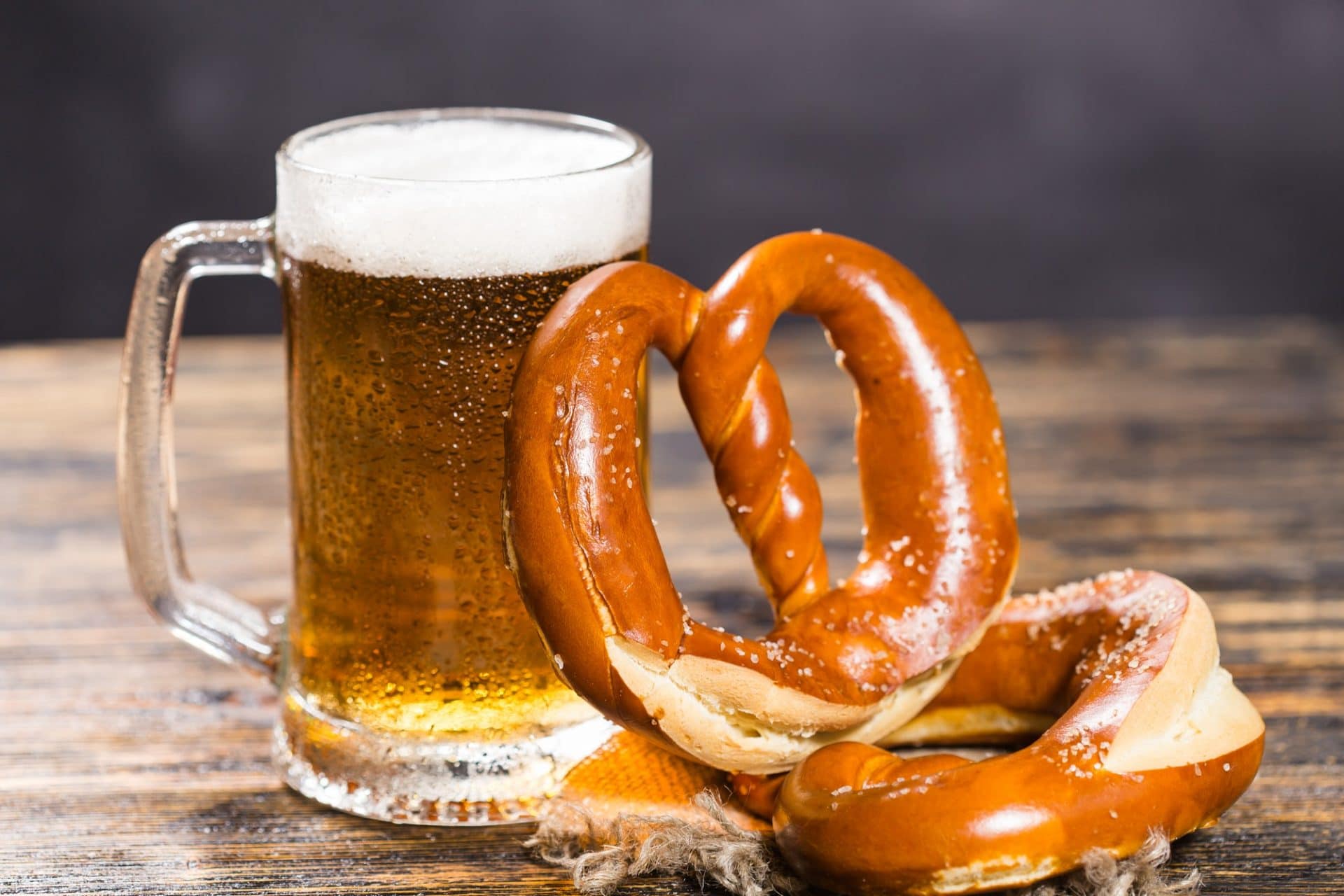 Food and drink concept - beer mug with german pretzel